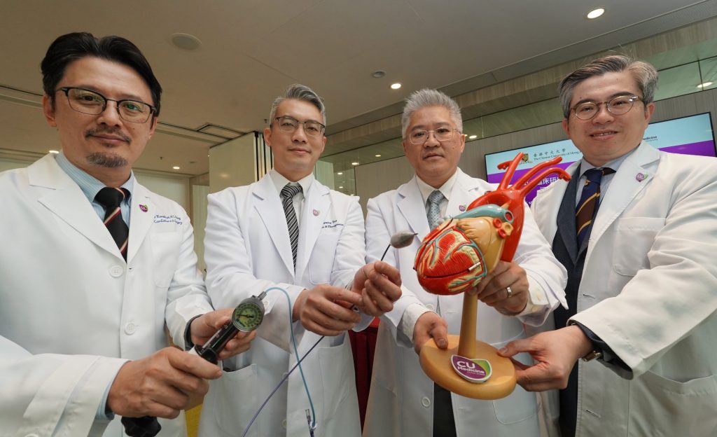 Four male doctors in white coats. Two hold a heart model; one holds a pressure gauge.