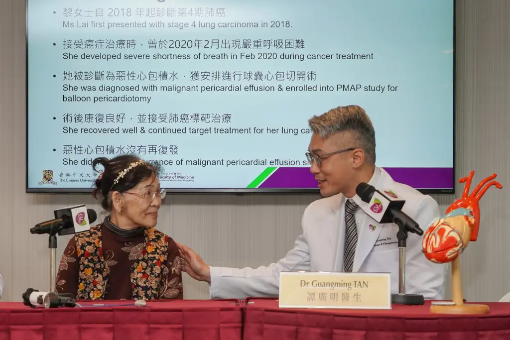 Dr. Tan and a woman at press conference, screen shows stage 4 lung cancer case.